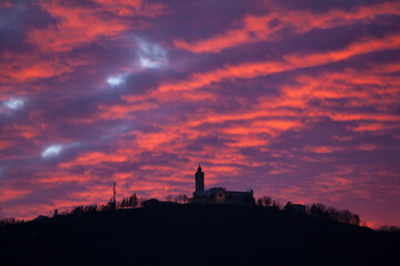 Copy space Red sunset over silhouette of Sveta Gora Nova Gorica Slovenia