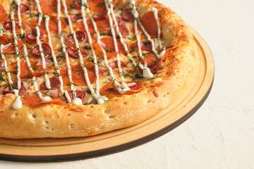 pizza with different types of sausages on a light background copy space