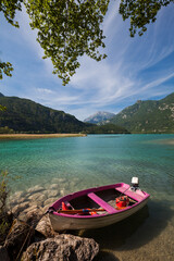 Pink boat on tranquil summer lake  - Lago dei tre comuni - Lago di Cavazzo  - obrazy, fototapety, plakaty