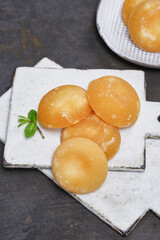 Several palm sugar cakes made from palm tree sap on a white boards. Shallow depth of field
