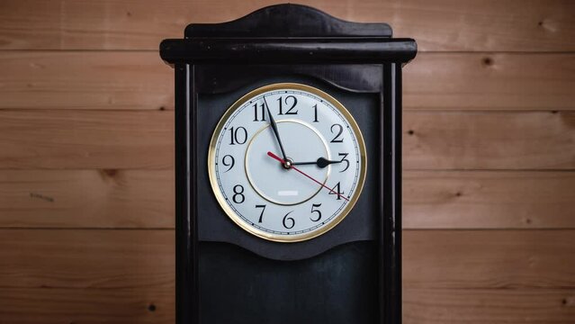 Vintage Clock Arrows Rotate at 3 PM or AM, Full Turn of Time Hands, Timelapse. Old Retro wall clock with second, minute, and hour hands on a white circular dial. An antique clock on wooden background