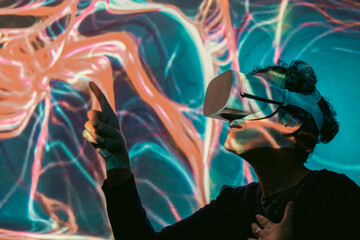 A woman wearing virtual reality glasses, cyber ​​space - obrazy, fototapety, plakaty