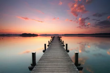 Zelfklevend Fotobehang magische zonsopgang op houten pier © Jenny Sturm