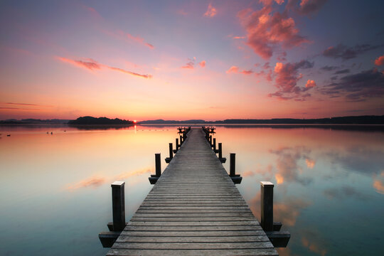 magical sunrise at wooden pier