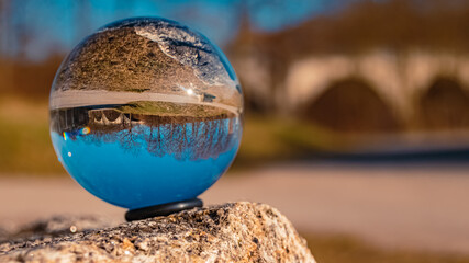 Crystal ball winter landscape shot with the famous Bockerlbahn cycle path in the background at...