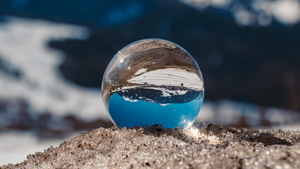 Fototapeta na wymiar Crystal ball alpine winter landscape shot at Lermoos, Tyrol, Austria