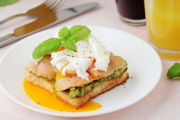 Fototapeta na wymiar Breakfast with a sandwich with poached egg and avocado