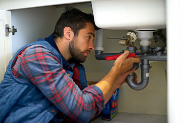 I think I see your problem. Shot of a plumber fixing a pipe.