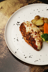 Grilled salmon and baked vegetable on a white plate