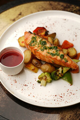 Grilled salmon and baked vegetable on a white plate