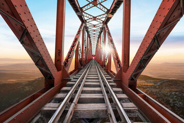 Red Railway Bridge against beautiful sunset view. - obrazy, fototapety, plakaty