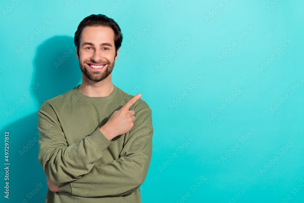 Wall mural Photo of nice brunet young guy index promo wear green shirt isolated on teal color background - Wall murals