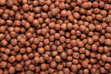 Chocolate breakfast cereal texture. Cereal balls as background. Chocolate corn balls.