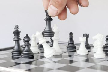 Businessman hand moving chess piece on board with challenges planning business strategy to success...