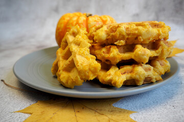 gluten-free pumpkin waffles are on a gray plate. healthy sweets. diet