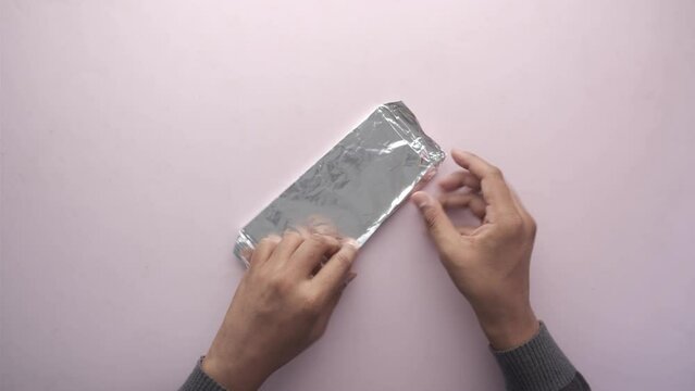open a packet of dark chocolate top view 