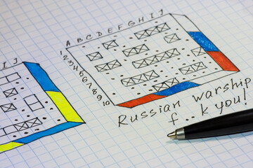 Aggression Russia to Ukraine as game sea battle in notebook. Russian war ship. Ukraine won!