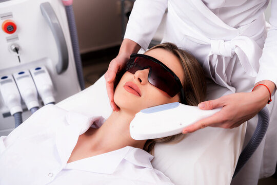 Laser hair removal photo. The device for depilation in the hands of a beautician. IPL apparatus.