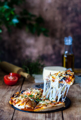 traditional italian pizza with stretching cheese