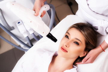 The concept of modern cosmetic procedures. Facial cleansing. The procedure of laser carbon peeling...