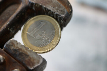 one euro coin in pincers - sanctions against russia from europe wallpaper