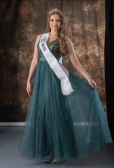 Fototapeta premium Beautiful woman. Miss contest. Beautiful dress. Long hair. Brunette