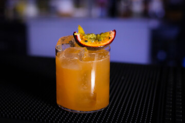 fresh passion fruit cocktail on a black background