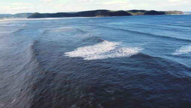 Drone aerial shot of jet ski waiting in waves swell ocean off Pearl Beach Umina Point Hawkesbury River NSW Australia Central Coast nature tourism 4K
