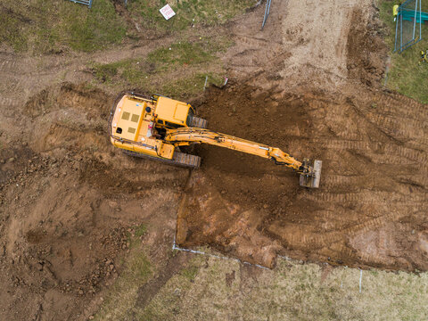 Aerial view of digger on house build construction site