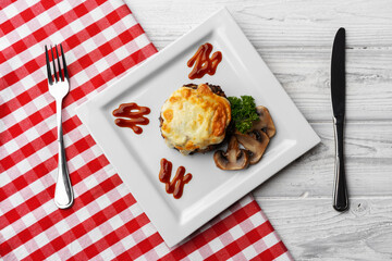 Delicious veal cutlet with melted mozzarella cheese on white plate