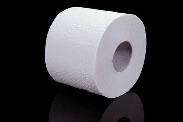 Toilet paper roll on a black background. Presentation of toilet paper roll, isolated on black background.