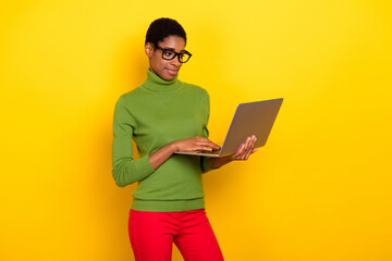 Photo of sweet charming trans woman wear green turtleneck typing modern device isolated yellow color background