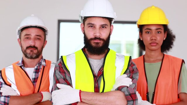 slow motion. Professional confident Mechanical civil Engineer and construction team at house project underconstruction site. Group portrait. Unity and teamwork concept. Look at camera