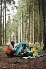 Women relaxing at their forest campsite
