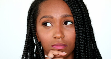 Pensive black African girl thinking, portrait teen daydreaming. Thoughtful contemplative young woman