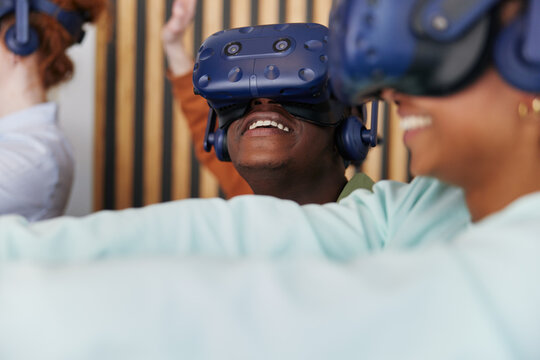 Smiling teens wearing vr headsets