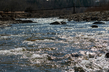 Mountain river in the mountains of Ukraine. Peremiyskaya river, Ivano-Frankivsk region. Spring 2022.