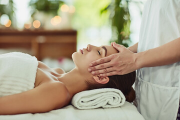 Give yourself the gift of relaxation. Shot of an attractive young woman getting massaged at a beauty spa.