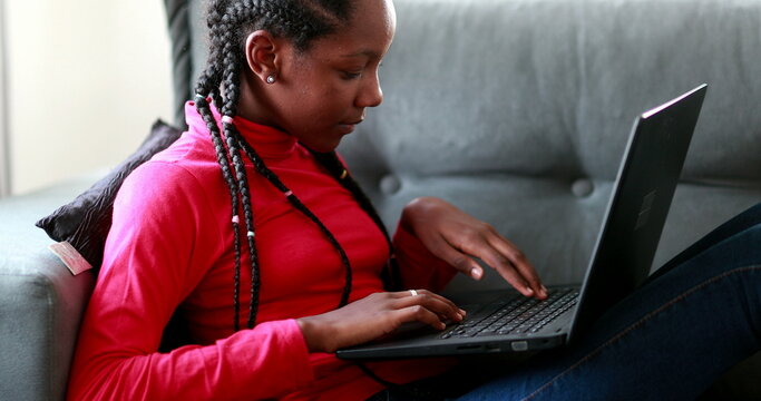 Child girl using laptop at home couch