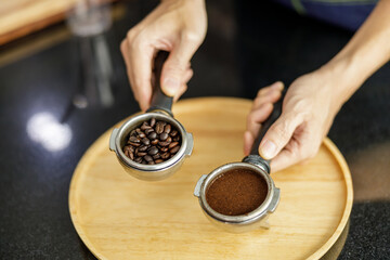 Fototapeta na wymiar Coffee Ground in Portafilter for Espresso in hand barista