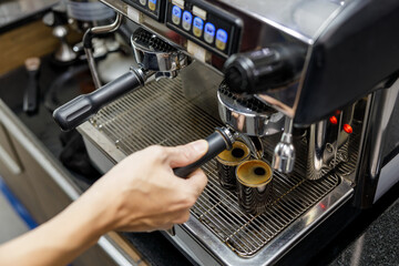 Barista make black coffee with coffee machine in cafe