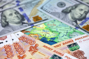 Russian rubles and US dollars on map of Ukraine. Concept of american support for Kiev during special military operation of Russia