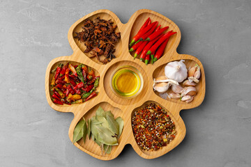 Oil, herbs and spices on wooden background