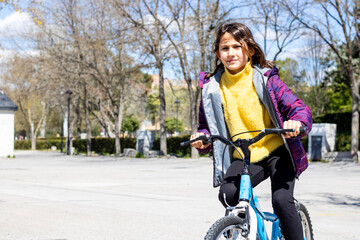 Girl riding a bike in the park 