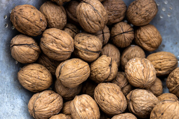 Plate full of walnuts close up full frame