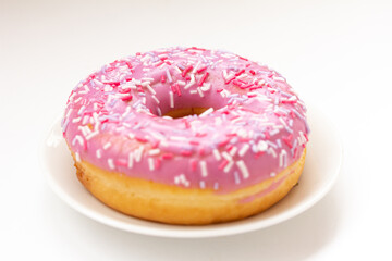 Pink Donut, doughnut with colorful sprinkles on white background.