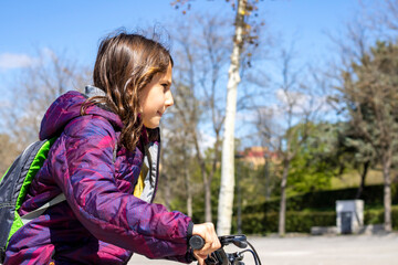 Girl riding a bike in the park 