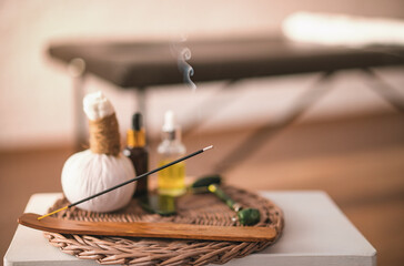 Happiness on a woman's face after a relaxing Thai massage. a table with incense in front of a girl on massage