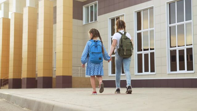 back to school. kids a walk to school for lesson. education training support concept. child walk to school with a backpack. kids rush to school. family day. group kids lifestyle with backpacks