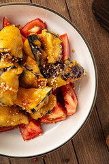 Bowl of sweet chili crispy battered eggplants salad